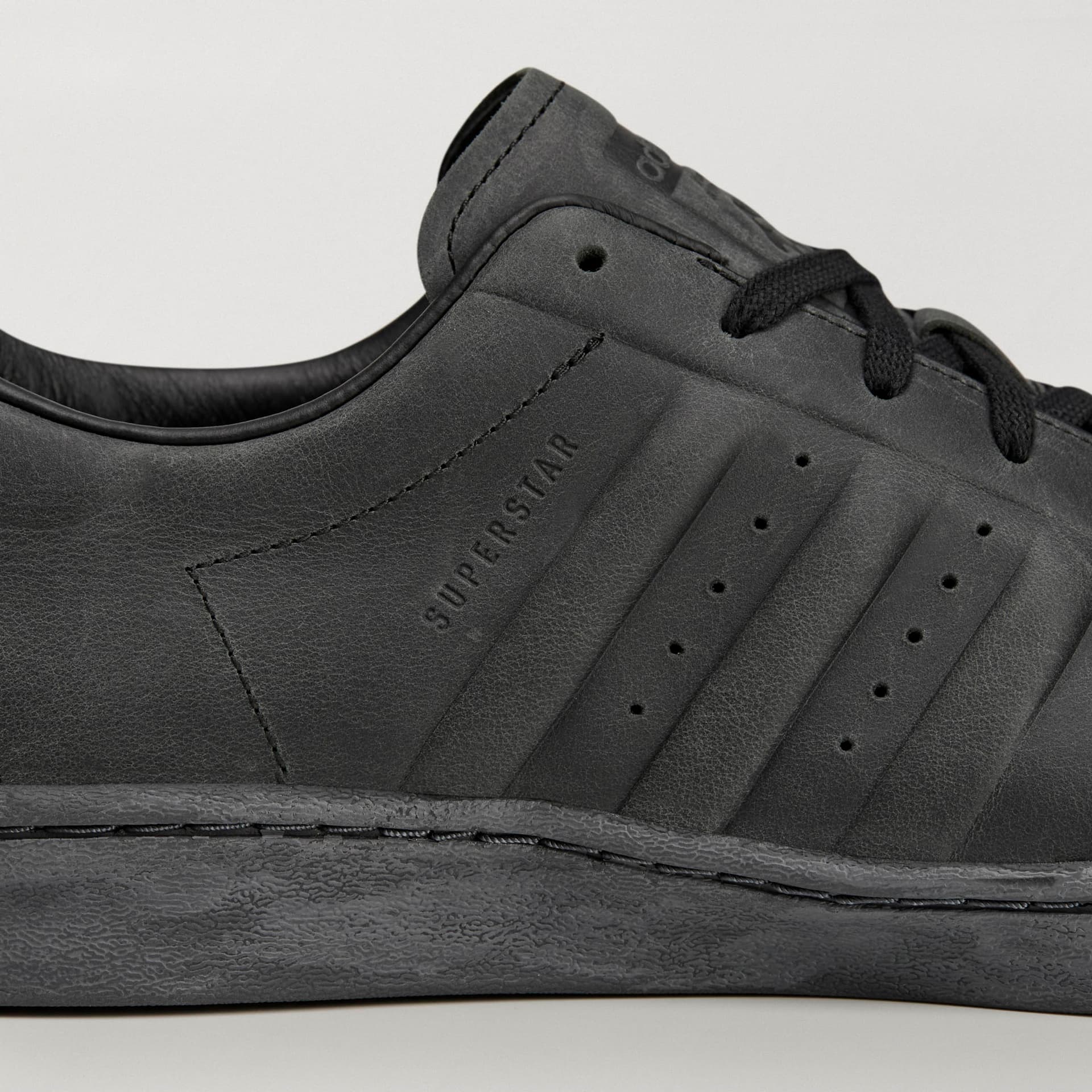 Close-up of the black adidas Originals by Avavav Modified Superstar, showing embossed leather stripes and SUPERSTAR logo.
