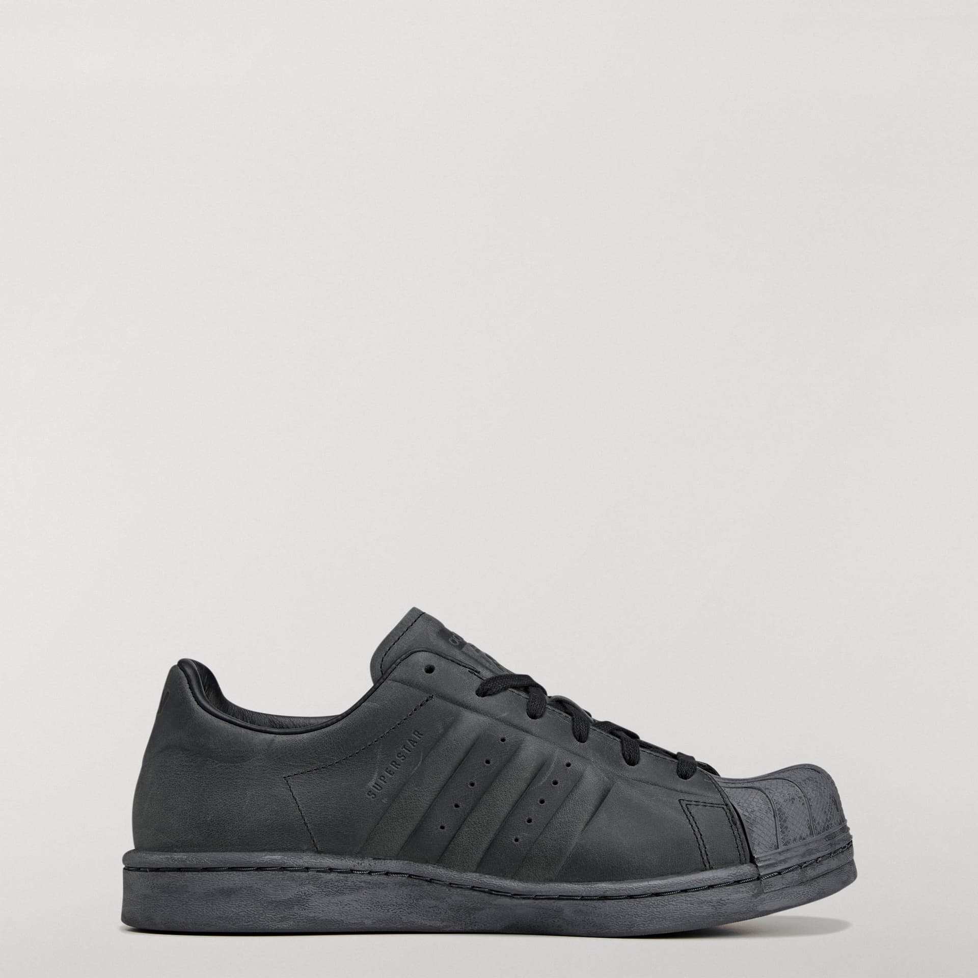 Side profile of the adidas Originals by Avavav Modified Superstar in all-black, with its reshaped sole and shell toe.