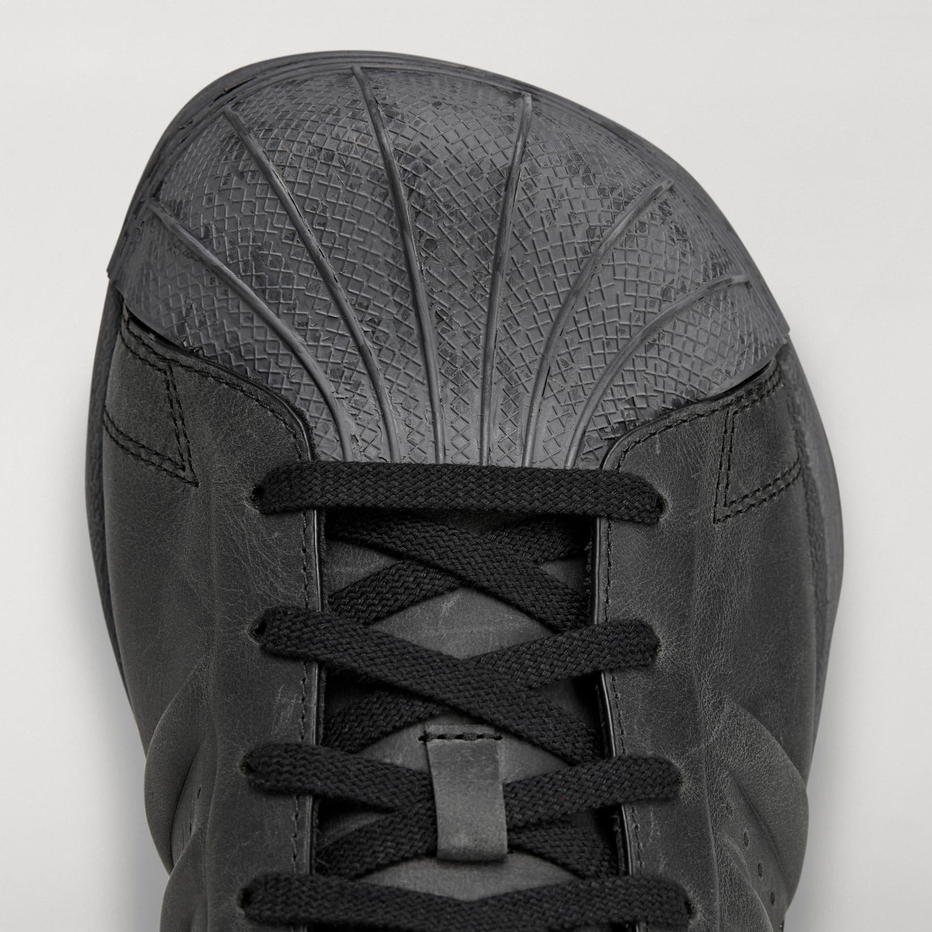Top-down detail shot of the black adidas Originals by Avavav Modified Superstar featuring the textured shell-toe and laces.